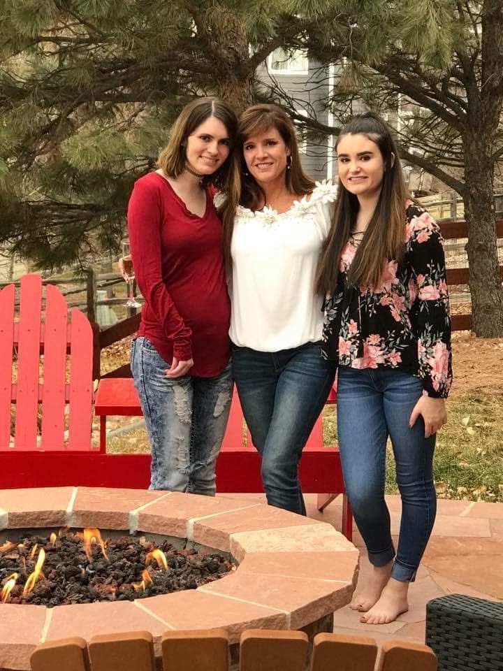 Anne Barrington with her daughters at a firepit