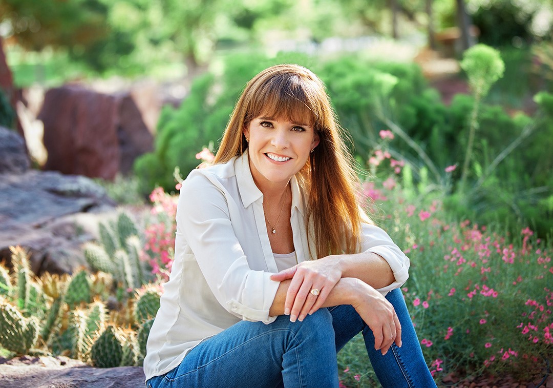 Anne Barrington smiling outdoors in a white shirt